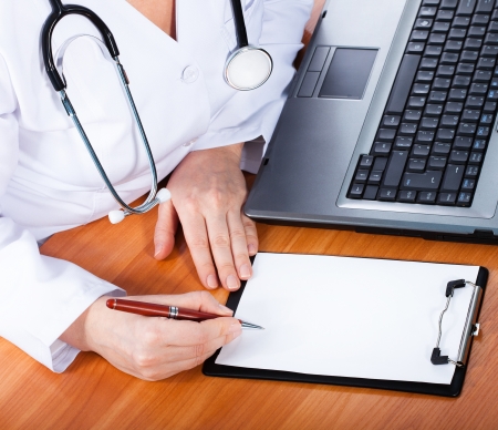 Female doctor showing blank clipboard の写真素材