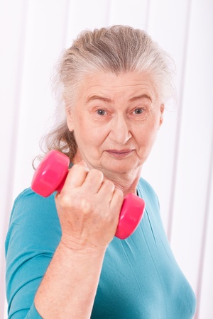 happy senior woman with dumbbellsの写真素材