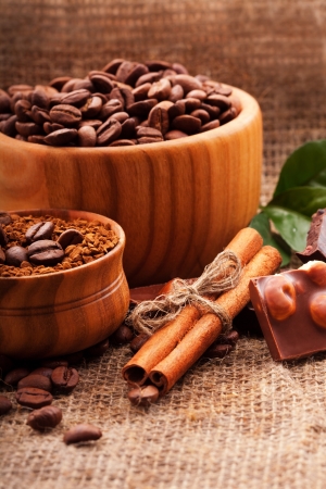 coffee beans in a wooden bowl on burlap backgroundの写真素材