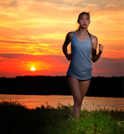 Portrait of a young woman jogging in nature. Close upの写真素材