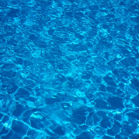Blue swimming pool rippled water detailの写真素材