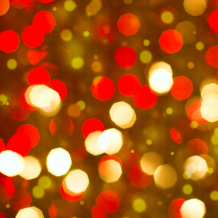 Red golden glowing background  Christmas card  Abstract background with bokeh defocused lights and starsの写真素材