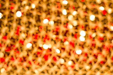 Red golden glowing background  Christmas card  Abstract background with bokeh defocused lights and starsの写真素材