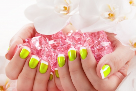Woman in nail salon receiving manicure by beauticianの写真素材