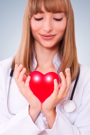 Health insurance or love concept. Doctor holding a heartの写真素材