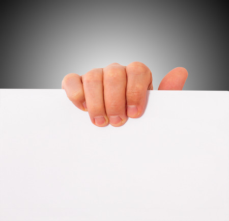 Advertising: Hand holding white empty paperの写真素材