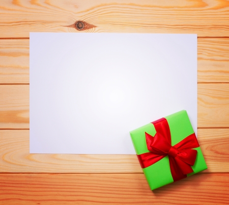 Christmas card. Vintage gift box (package) with blank gift tag on old wooden background.の写真素材
