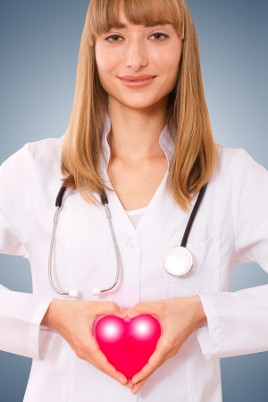 Female doctor holding heart  the concept of health insurance, life insuranceの写真素材