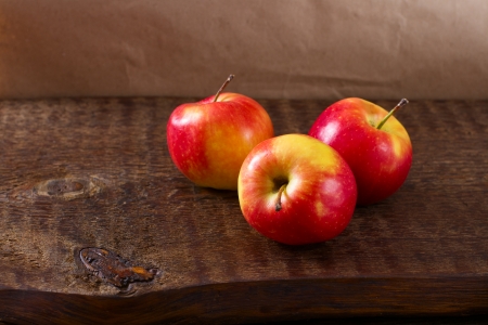 red apples on a wooden table still life close upの写真素材