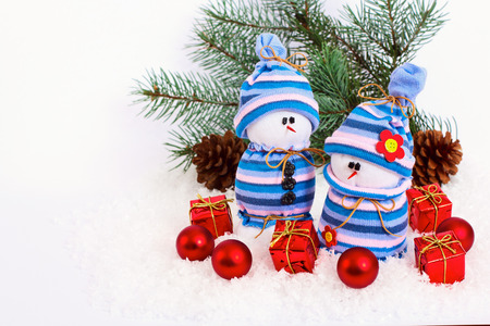 composition with Christmas snowmans and red bauble fir branches isolated on white backgroundの写真素材