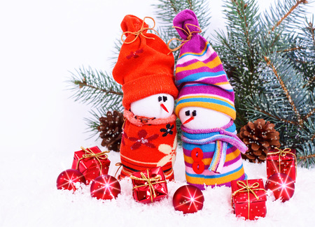 composition with Christmas snowmans and red bauble fir branches isolated on white backgroundの写真素材