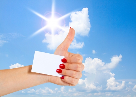 female teen hand shows thumbs up, isolated on whiteの写真素材