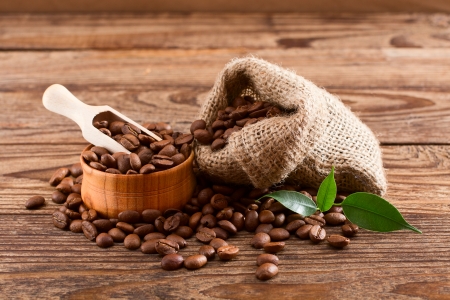cup of warm coffee and coffee grinder on wood textureの写真素材