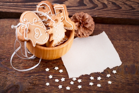 Gingerbread cookies hanging over wooden . Christmas cardの写真素材