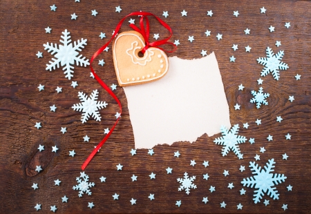 Gingerbread cookies hanging over wooden background. Christmas cardの写真素材