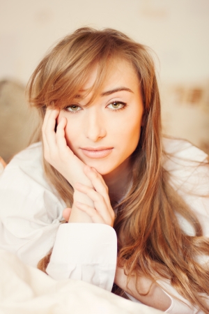 Portrait of  beautiful young woman with  sexy look in the morning in bedの写真素材