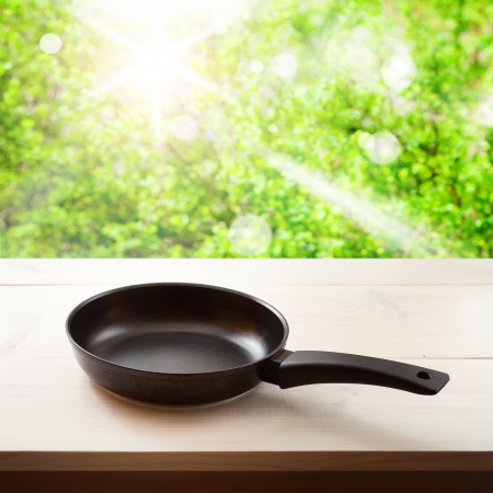 Empty frying pan on wooden background. Space for text, squareの写真素材