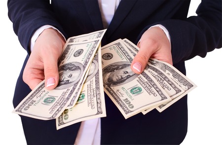 Bbusiness woman holding Money Cash Dollars in hands. Concept of Finance Success. Isolated, space for texの写真素材