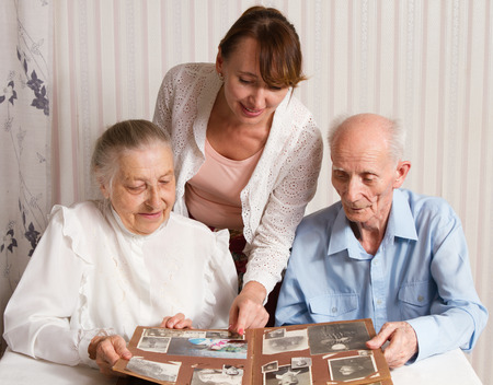 Senior Man, Woman with their Caregiver at Home  Concept of Health Care for Elderly Old People, Disabledの写真素材