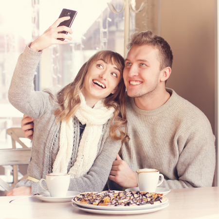 Portrait of Beautiful Young Couple in Love in cafe  Concept of relationship, love story, preparations for wedding の写真素材
