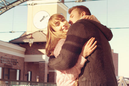 Portrait of Beautiful Young Couple in Love on nature. Man and Woman Smiling Charmingly. Young Couple Kissing Summer on Sunny Sky Backgroundの写真素材