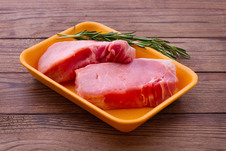 Food. Sliced ââpieces of raw meat for barbecue with fresh vegetables and mushrooms on wooden surface. Meat raw steak. Beef steak bbq. Tomatoes, peppers, spices for cooking meat.の写真素材