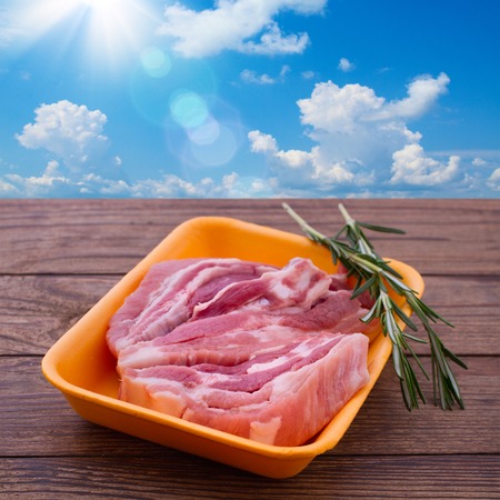 Raw meat for barbecue on wooden surface. Raw meat steak. Food , spices for cooking meat.の写真素材