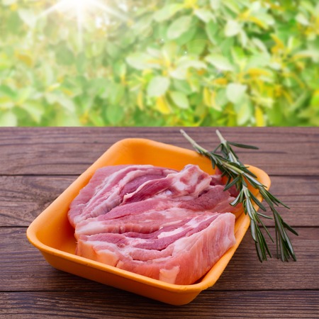 Raw meat for barbecue on wooden surface. Raw meat steak. Food , spices for cooking meat.の写真素材