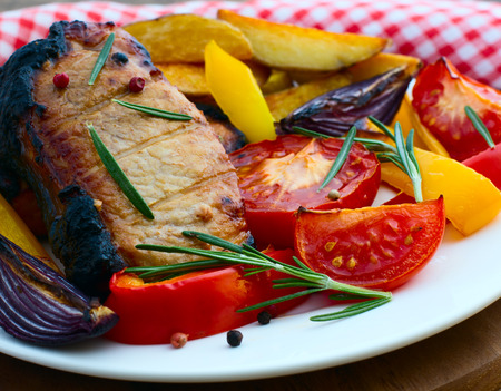 Food. Meat barbecue with vegetables on wooden surface. Meat steak. Beef steak bbq. Tomatoes, peppers, spices for cooking meat.の写真素材