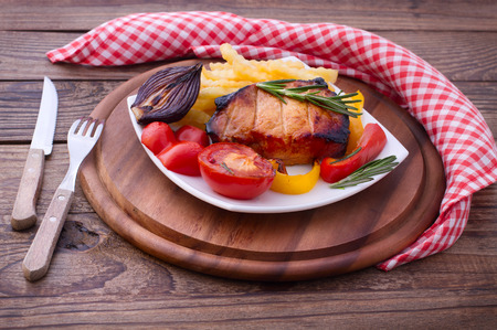 Food. Meat barbecue with vegetables on wooden surface. Meat steak. Beef steak bbq. Tomatoes, peppers, spices for cooking meat.の写真素材