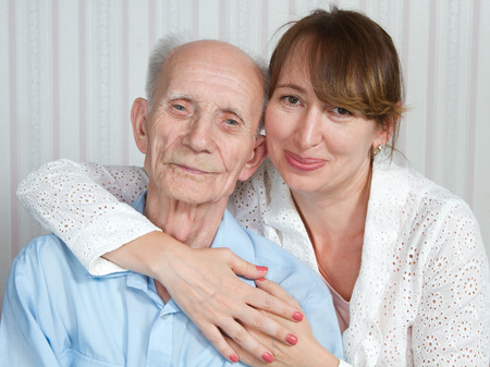 Senior man, woman with their caregiver at home. Concept of health care for elderly old people, disabledの写真素材