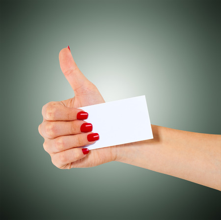 Hand hold blank business card, showing thumbs up, sign okayの写真素材