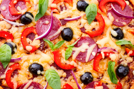 Pizza with ham, pepper and olives  Delicious fresh pizza served closeup  Pizza with tomato, salami and olivesの写真素材