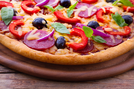 Pizza with ham, pepper and olives  Delicious fresh pizza served on wooden table  Pizza with tomato, salami and olivesの写真素材