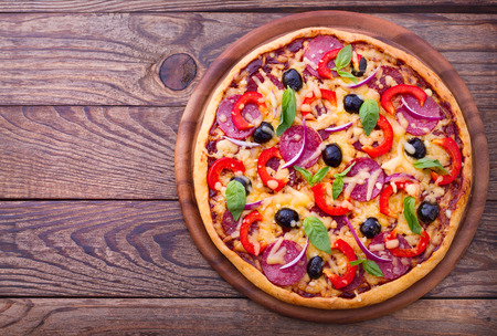 Pizza with ham, pepper and olives  Delicious fresh pizza served on wooden table  Pizza with tomato, salami and olivesの写真素材