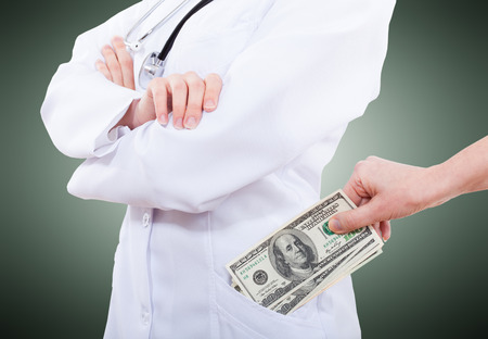Woman giving bribe to doctor, closeup isolatedの写真素材