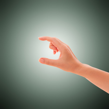 Hand holds virtual credit card, business card, thing  isolatedの写真素材