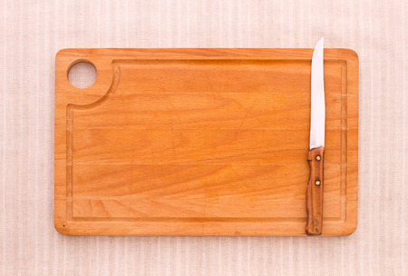 Cutlery on tablecloth burlap sacking wooden table close up view from top wooden kitchen cutting board retro. Product pages for installation recipe books menuの写真素材