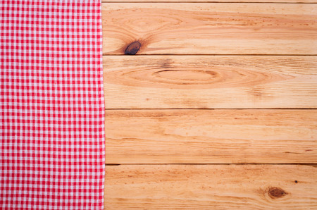 Pure notebook for recording menu, recipe on red checkered tablecloth tartan. Wooden table close up view from topの写真素材
