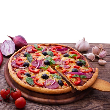 Pizza with ham, pepper and olives. Delicious fresh pizza served on wooden table.の写真素材