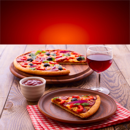 Pizza with ham, pepper and olives. Delicious fresh pizza served on wooden table.の写真素材
