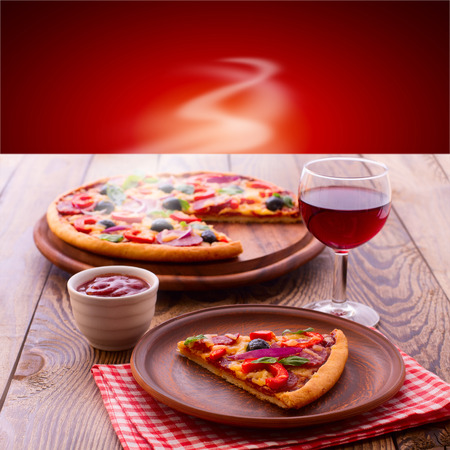 Pizza with ham, pepper and olives. Delicious fresh pizza served on wooden table.の写真素材
