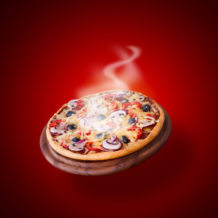 Pizza with ham, pepper and olives. Delicious fresh pizza served on wooden table.の写真素材