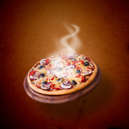 Pizza with ham, pepper and olives. Delicious fresh pizza served on wooden table.の写真素材