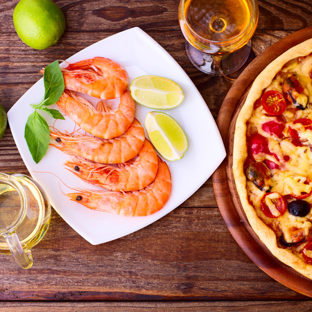 Pizza with seafood. Seafood Italian Pizza slice on wood dish originality. Italian kitchen studio.の写真素材