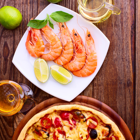Pizza with seafood. Seafood Italian Pizza slice on wood dish originality. Italian kitchen studio.の写真素材