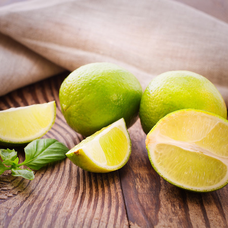 Food citrus fruits. Fresh limes on wooden background.の写真素材