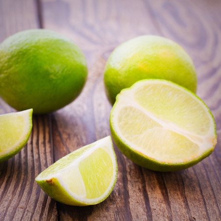 Food citrus fruits. Fresh limes on wooden background.の写真素材