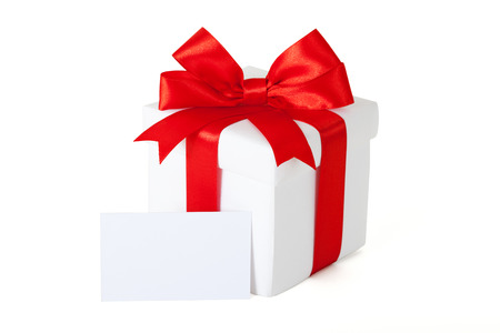 Single box with red ribbon and gift card on white backgrounの写真素材