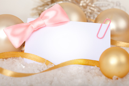 Business card with bow and Christmas decorations closeup.の写真素材